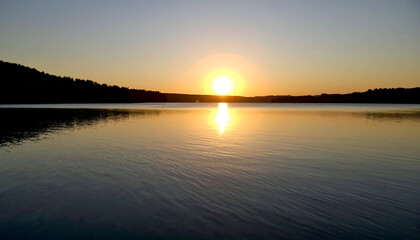 Naklejka premium Sunset over calm lake with serene nature.