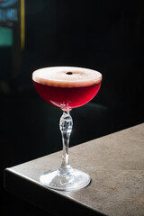 A vibrant red cocktail awaits in a sleek glass for a glamorous evening
