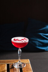 With vibrant hues and rose petals, this cocktail invites relaxation in a serene lounge