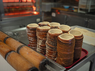 Traditional baked pastries arranged on a tray with wooden rolling pins in a warm kitchen setting