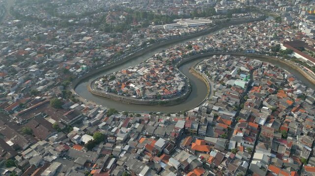 Crowded Jakarta Neighborhood Of Tebet With Canal Winding Through Drone Track Back 4K 60FPS