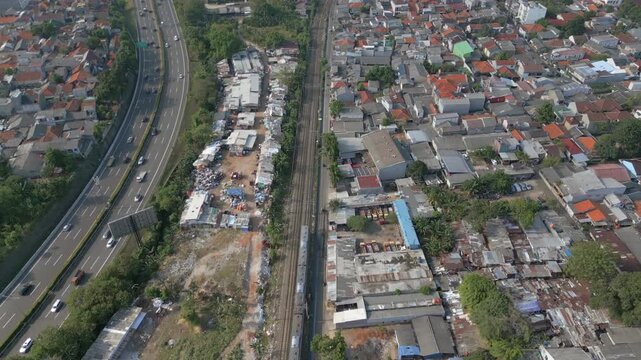 Train Passes By Bintaro Neighborhood Disaster Site Peacefully In Jakarta Indonesia Drone Shot 4K 60FPS