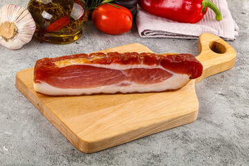 Piece prosciutto crudo over board
