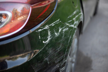 Scratches on a car door. Vertical scratches a result of a collision. Damage on both left door requiring repair and painting.