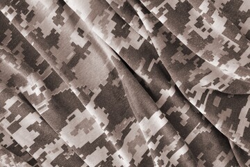 Texture of Dark green pixel camouflage military uniform textile cloth with folds