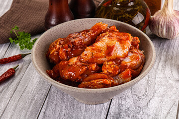 Raw marinated buffalo chicken wings