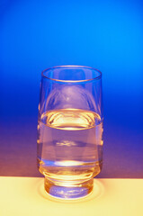 glass of water on blue background 