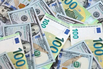 Big pile of Euro and USD banknotes. Many european and united states dollars