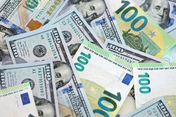 Big pile of Euro and USD banknotes. Many european and united states dollars