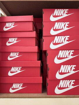 Red nike boxes stacked neatly in a retail display at a store in penang, malaysia on april 23, 2025