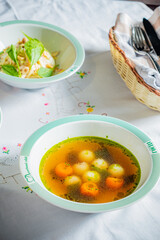 A comforting bowl of aromatic vegetable soup with carrots, herbs, and a light broth