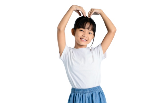 A young girl forms a heart shape with her hands, expressing love and affection. She smiles at the camera wearing a white shirt and blue skirt on PNG 