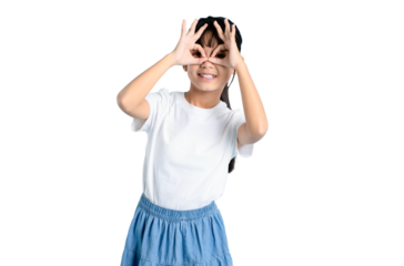 A cheerful young girl playfully making an okay sign with her hands, smiling and looking through the makeshift glasses on PNG 