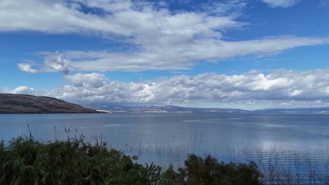 Flying to The Sea of Galilee from the trees Under a Blue Sky with Clouds