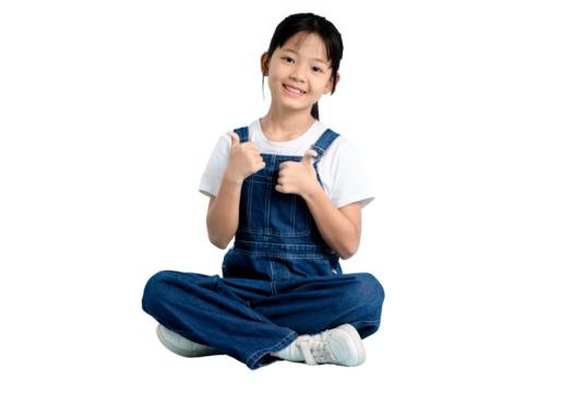 A young girl sits cross-legged, smiling and giving a thumbs-up gesture on PNG 