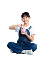 A young girl putting a coin into a piggy bank, representing savings and financial responsibility on...
