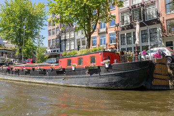 Obraz premium Amsterdam, Netherlands - July 02, 2018: Floating houses on the water in the center of Amsterdam