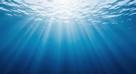 Obraz premium Sunlight shining through ocean surface into deep blue water