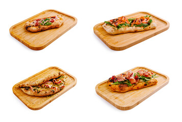 Baked flatbreads topped with fresh ingredients displayed on wooden boards
