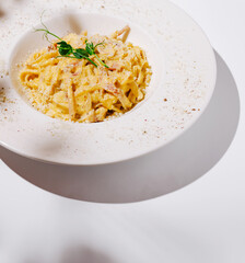 Delicious creamy pasta dish served on a vibrant white plate