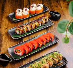 Delicious sushi assortment served on elegant black plates at a sushi restaurant