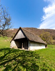 Fototapeta premium Rustic barn in a sunlit meadow