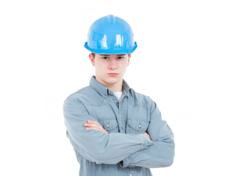 Young man wearing blue hard hat arms crossed serious expression light denim shirt isolated on transparency background construction worker safety equipment confident professional pose