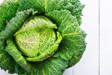 savoy cabbage from organic grower farm, on white wood table