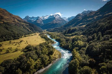 Aerial View Of Turquoise River Winding Through Green Valley And Mountains
