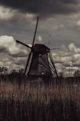 Dark and moody Dutch windmill with a mystic, eerie atmosphere