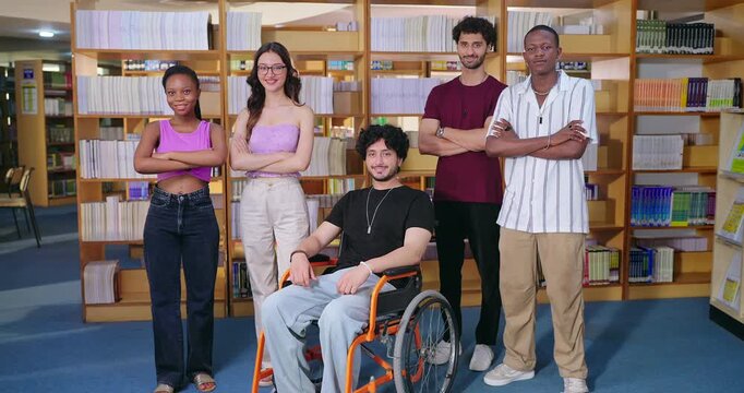 Indian young adult gen z man woman group team proud fold hand look camera indoor place teen girl pupil boy sitting in wheel chair class mate do casual pose cross arms staring cam enjoy new day time