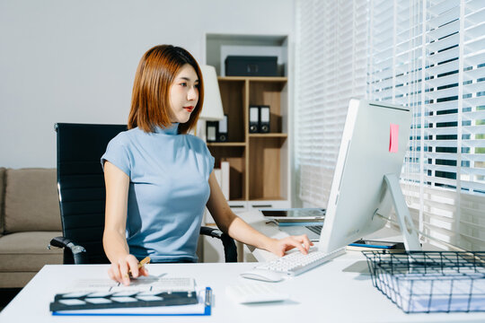 Businesswoman in yellow blazer planning strategy with charts and reports, perfect for corporate, teamwork, and office productivity concepts.