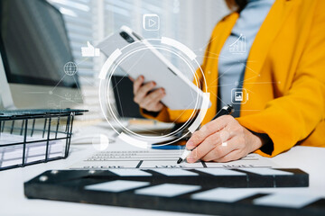 Businesswoman in yellow blazer planning strategy with charts and reports, perfect for corporate,...