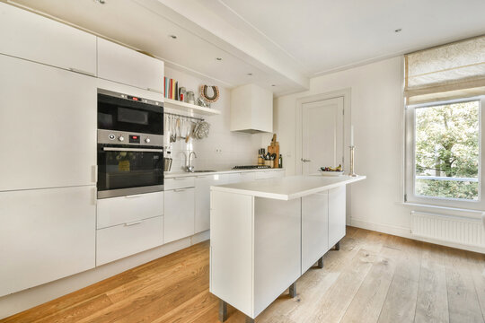 Modern minimalist kitchen with white cabinetry and island