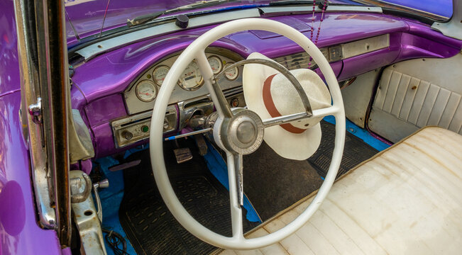Fototapeta Vintage car taxi interior in Havana, Cuba