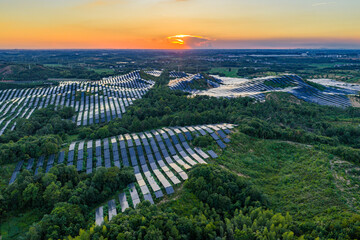 Photovoltaic panels on a hillside at sunset