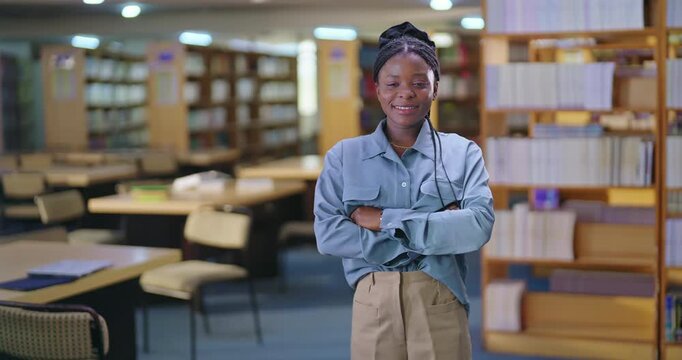 african young adult gen z lady student standing proud fold hand look camera indoor library happy smiling girl cross arm staring cam do casual pose ready for exam enjoy day time inside college