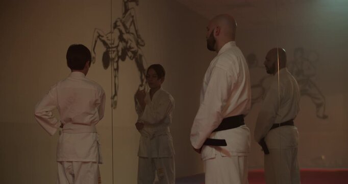 Young student in traditional karate kimono practices martial arts