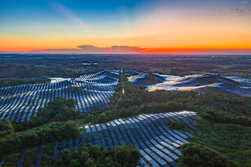 Photovoltaic panels on a hillside at sunset