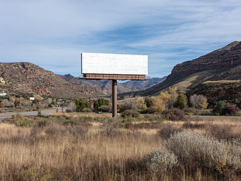 Empty Billboard Rural Highway Mountains Scenic Travel Route Nature Serenity Panoramic View North America Clear Sky Wilderness Vacant Design Tourism Rustic Exploration Geological Formation Grassland