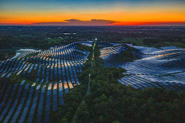 Photovoltaic panels on a hillside at sunset