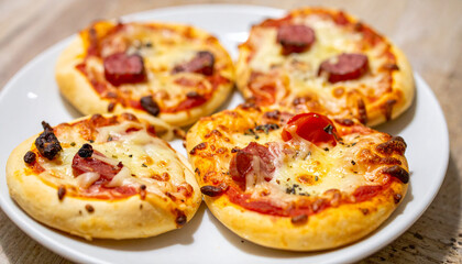 Freshly baked mini pizzas on white plate. Tasty fast food. Delicious meal. Cooking and culinary