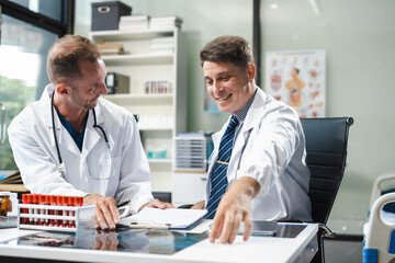 Medical team working with a tablet and Laptop computer search for medical information.