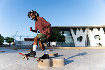 Person performing skateboard trick outdoors in urban setting