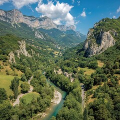 Aerial View Of Scenic Alpine Valley With River And Mountainous Landscape