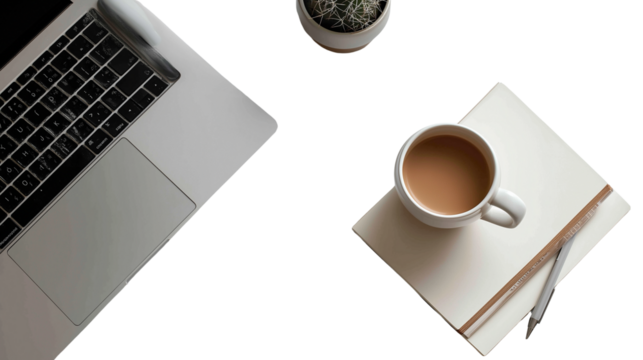 laptop on white desk with notebook and coffee cup