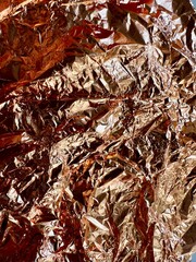 abstract background of crumpled paper, crumpled metal, bronze texture 