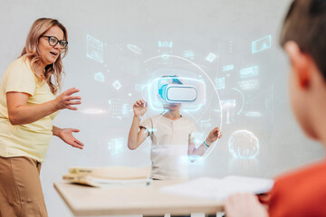 Teacher guiding schoolboy exploring virtual reality in classroom