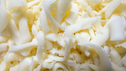 Shredded ivory cheese nestles like silk ribbons, evoking Cheesemonger Day and Dairymans Delight amidst creamy culinary dreams