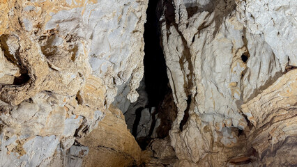 Eroded limestone cave walls whisper forgotten tales from Earth's belly, evoking curiosity on National Caves and Karst Day